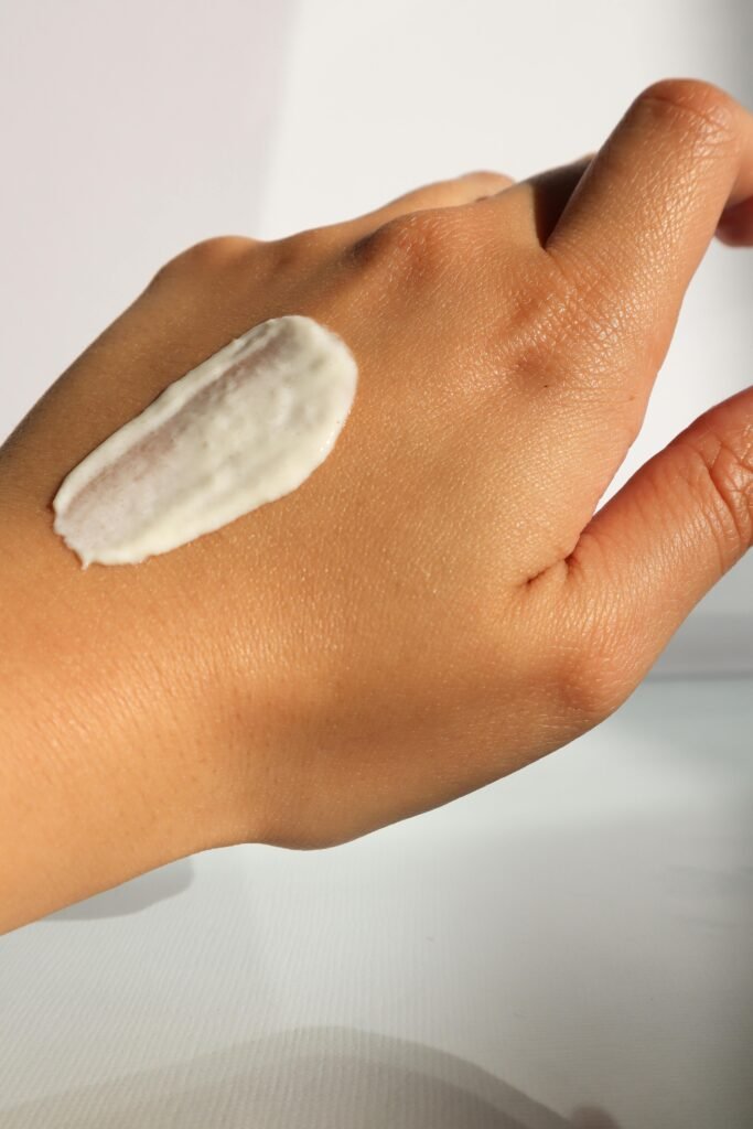 A close-up image of a hand with skincare cream applied, highlighting self-care and skin health.
